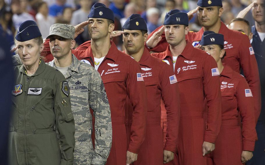Brig. Gen. Jeannie Leavitt, left, and other Air Force personnel salute during the singing of the national anthem U.S. Air Force Night at Nationals Park in Washington, D.C., Sept. 17, 2017.