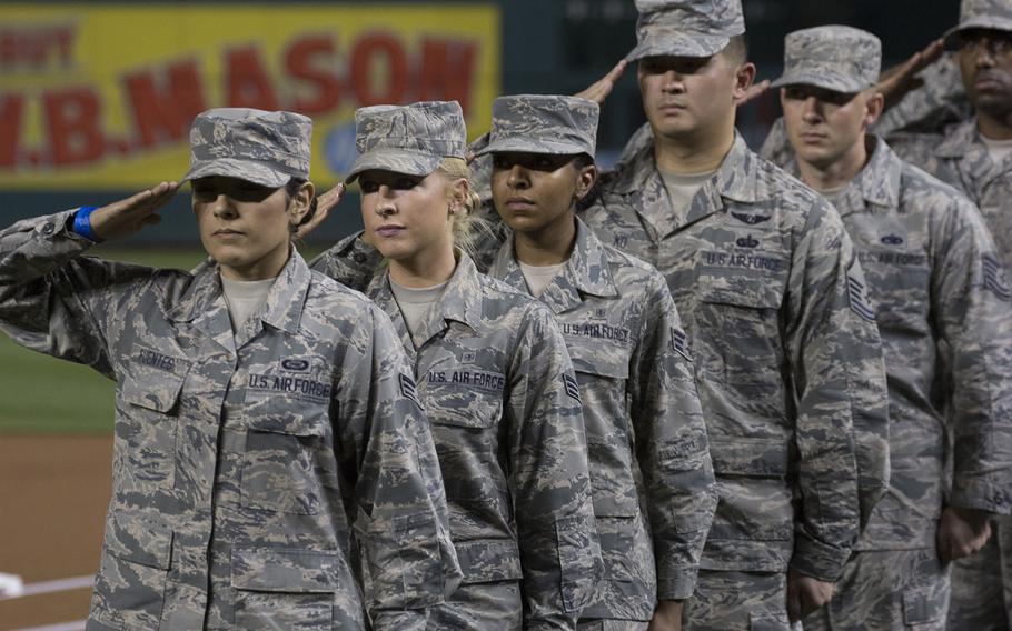 Airmen salute during the singing of the national anthem on U.S. Air Force Night at Nationals Park in Washington, D.C., Sept. 17, 2017.