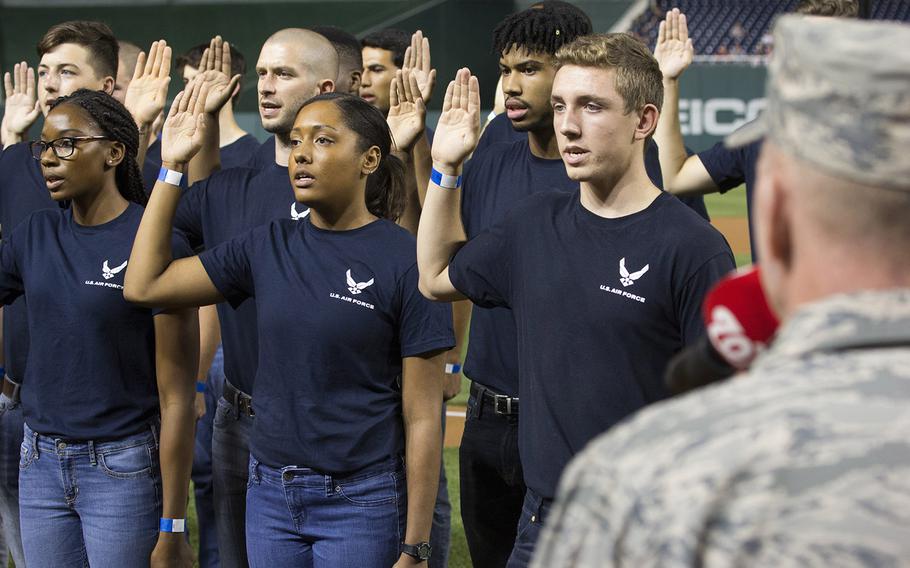 Gen. Stephen Wilson, vice chief of staff of the U.S. Air Force, administers the Oath of Enlistment to 46 recruits on Air Force Night at Nationals Park in Washington, D.C., Sept. 17, 2017.