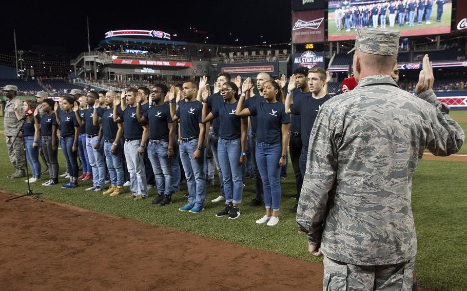 Gen. Stephen Wilson, vice chief of staff of the U.S. Air Force, administers the Oath of Enlistment to 46 recruits on Air Force Night at Nationals Park in Washington, D.C., Sept. 17, 2017.