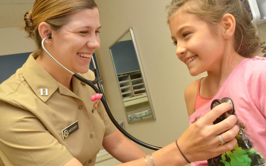 Lt. Allison Wessner, a pediatrician at Naval Hospital Jacksonville, conducts a check-up on a young patient on Aug. 3, 2017. The Defense Health Agency says it has embraced and begun to adopt a host of recommendations to improve health care services for military children.