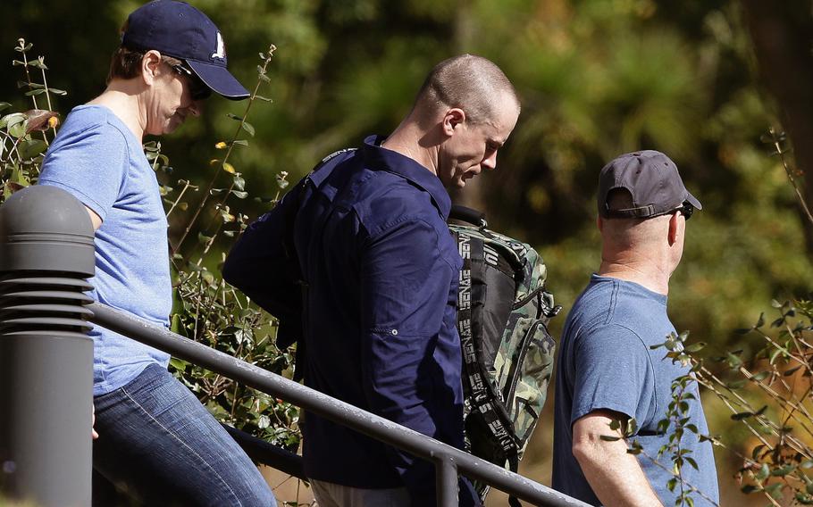 Bowe Bergdahl, center, leaves the Fort Bragg courtroom facility following sentencing at Fort Bragg, N.C., Friday, Nov. 3, 2017. The former Sergeant was spared any prison time and received a dishonorable discharge from the Army.