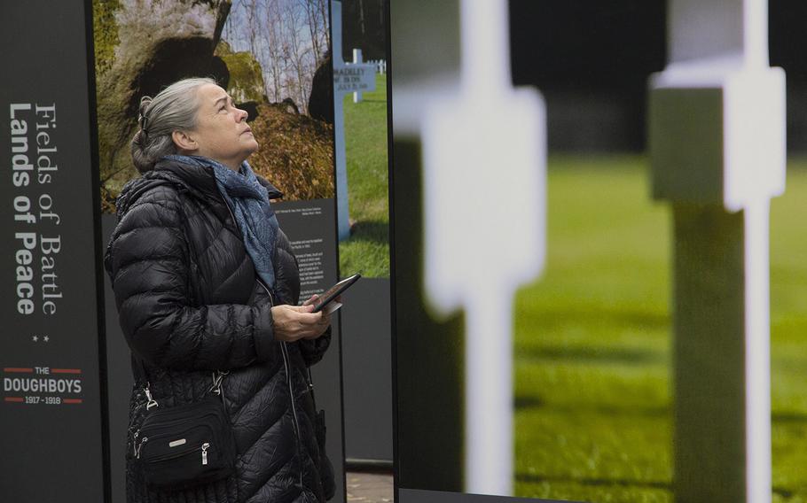 A visitor looks at the display of photos of World War I battlefields taken by Michael St. Maur Sheil at the groundbreaking ceremony for the National World War I Memorial at Pershing Park in Washington, D.C., Nov. 9, 2017.