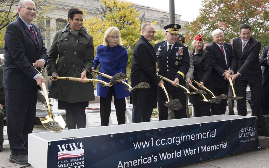 Dignitaries turn the ceremonial first shovelful of dirt doring the groundbreaking ceremony for the National World War I Memorial at Pershing Park in Washington, D.C., Nov. 9, 2017.