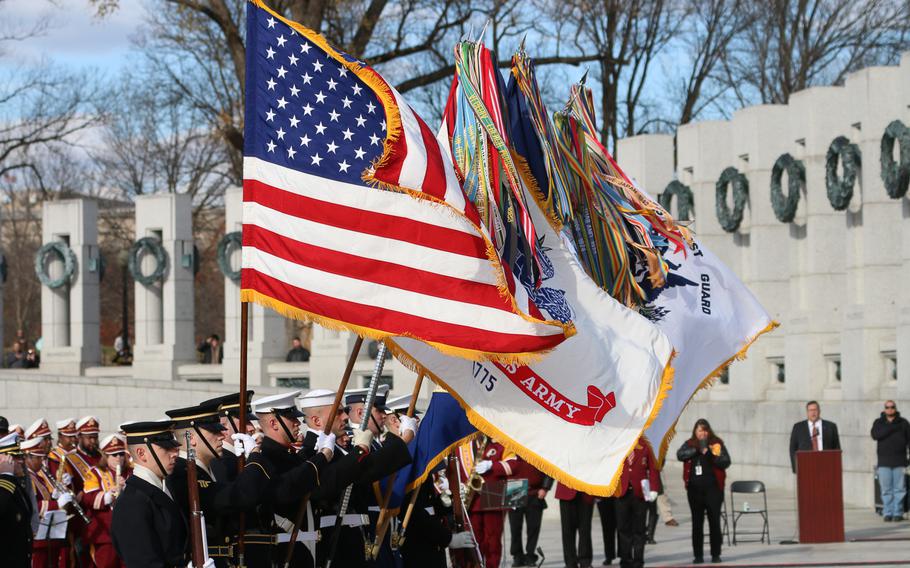 The colors fly at a remembrance ceremony held in Washington, D.C. on the 76th anniversary of the Japanese attack on Pearl Harbor, Thursday, Dec. 7, 2017.