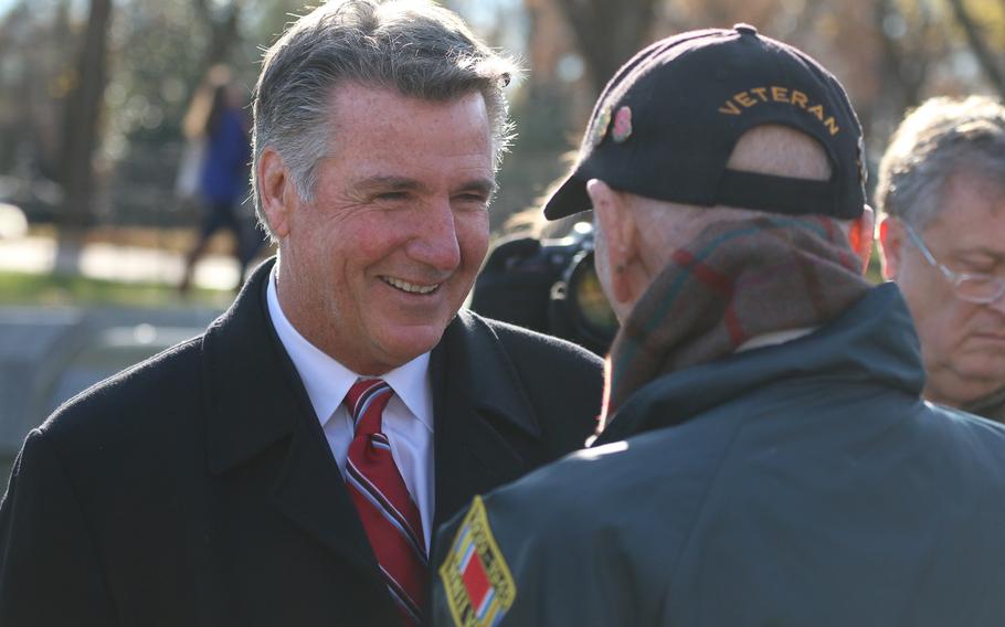 Bruce Allen, owner of the Washington Redskins football team meets with a World War II veteran after a wreath-laying ceremony held in Washington, D.C. as part of the remembrance for the 76th anniversary of the Japanese attack on Pearl Harbor.  