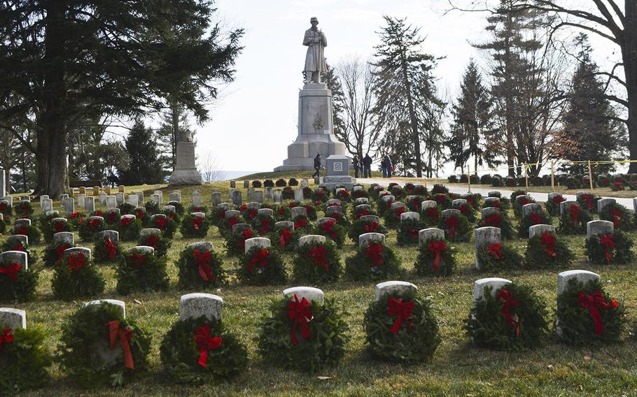Graves are adorned with wreaths during Wreaths Across America at Antietam National Cemetery in Sharpsburg, Md., December 16, 2017. In the background is the Private Soldier Monument.