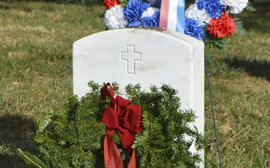 The grave for Navy Fireman Patrick Howard Roy, one of the 17 sailors who died during the bombing of the USS Cole in 2000, is decorated with a wreath during Wreaths Across America at Antietam National Cemetery in Sharpsburg, Md., December 16, 2017.