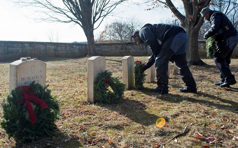 Keith "Tiny" Nelson, left, and Franklin Johnson, aka Sgt. Rock, place wreaths at the graves of six African-American soldiers during Wreaths Across America at Antietam National Cemetery in Sharpsburg, Md., December 16, 2017.