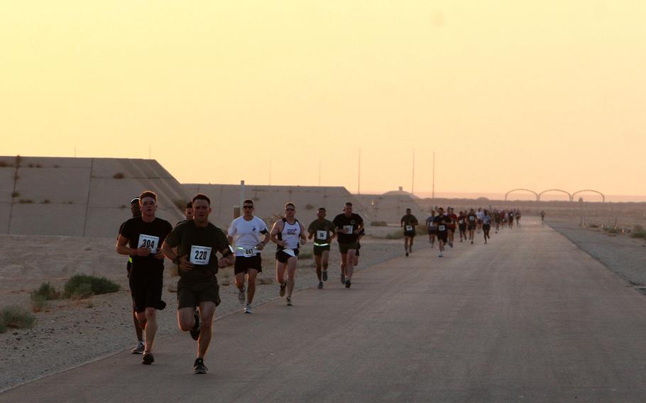 U.S. servicemembers and civilians run a half marathon at Al Asad Air Base, Iraq, Aug. 15, 2009. The Pentagon is reviewing the use of wireless technology, including fitness bands such as Fitbits and smartphones at military installations.