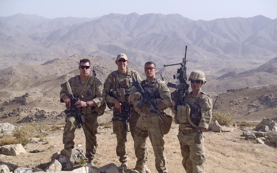 Former Army combat medic Dennis Magnasco, center right, is shown in Afghanistan with other soldiers. Magnasco, who now works in the office of Rep. Seth Moulton, D-Mass., is putting out the call for gun reform along with other combat veterans.