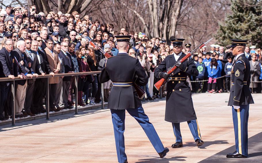 Ceremonial Army guards perform a change-of-the-guard routine before the start of a special wreath-laying ceremony at Arlington National Cemetery's Tomb of the Unknowns on Friday, March 23, 2018. More than two dozen Medal of Honor recipients, taking part in events to commemorate National Medal of Honor Day, were among a crowd of onlookers observing the ritual.