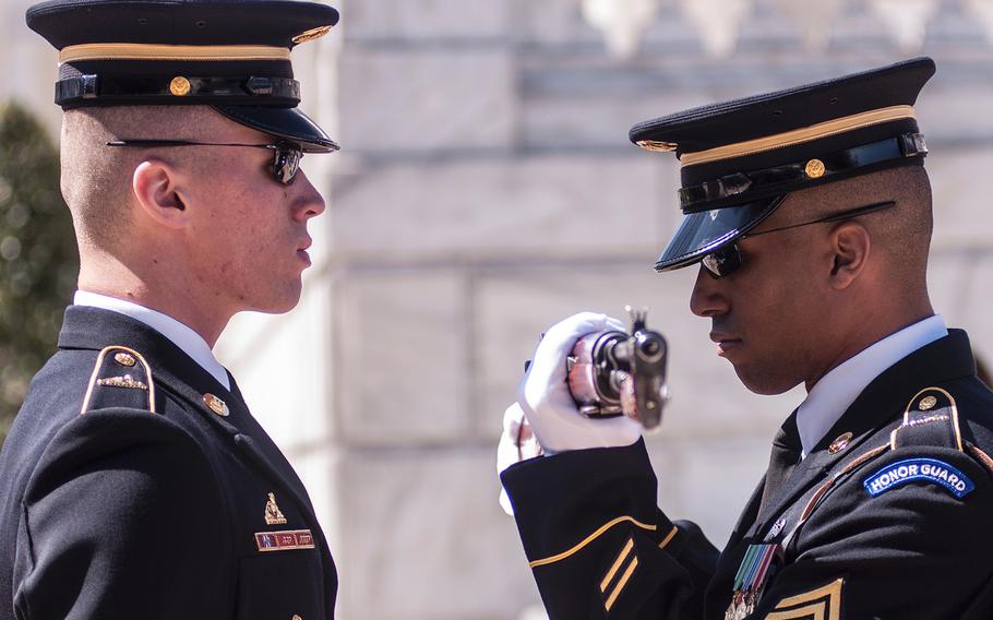 Ceremonial Army guards perform a change-of-the-guard routine before the start of a special wreath-laying ceremony at Arlington National Cemetery's Tomb of the Unknowns on Friday, March 23, 2018. More than two dozen Medal of Honor recipients, taking part in events to commemorate National Medal of Honor Day, were among a crowd of onlookers observing the ritual.