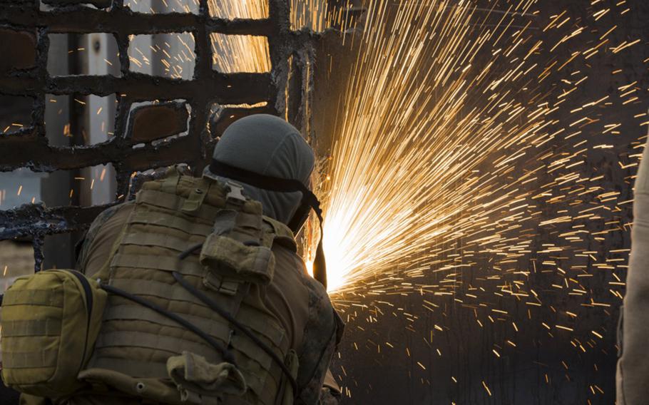 A U.S. Marine uses a torch to cut through steel aboard Camp Upshur, Quantico Va., Jan. 25, 2018. Vast quantities of the metals are used by the military to construct and repair ships, tanks to aircraft. 