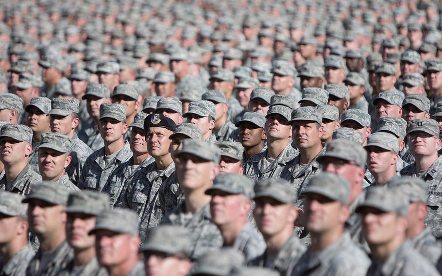 Soldiers and airmen from the Arizona National Guard assemble in a mass formation during the Arizona National Guard Muster on Dec. 7, 2017, in Tempe, Ariz. 