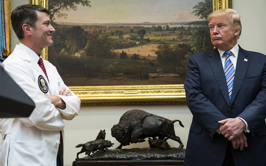 President Donald Trump looks to White House physician Ronny Jackson during a Veterans Affairs Department "telehealth" event in the Roosevelt Room of the White House in Washington on Aug 03, 2017.