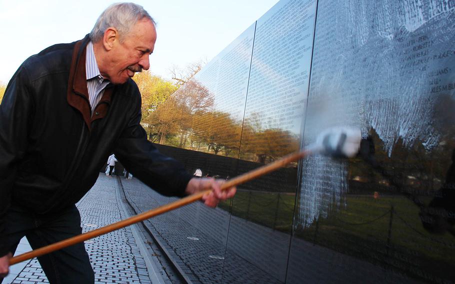 Former Vietnam Veterans Memorial Fund leader Jan Scruggs joins more than 40 volunteers in cleaning the Vietnam Wall in Washington, D.C., Saturday, April 21, 2018. It was Scruggs' first visit to the memorial he helped build since spending 28 days in a coma last year due to endocarditis.