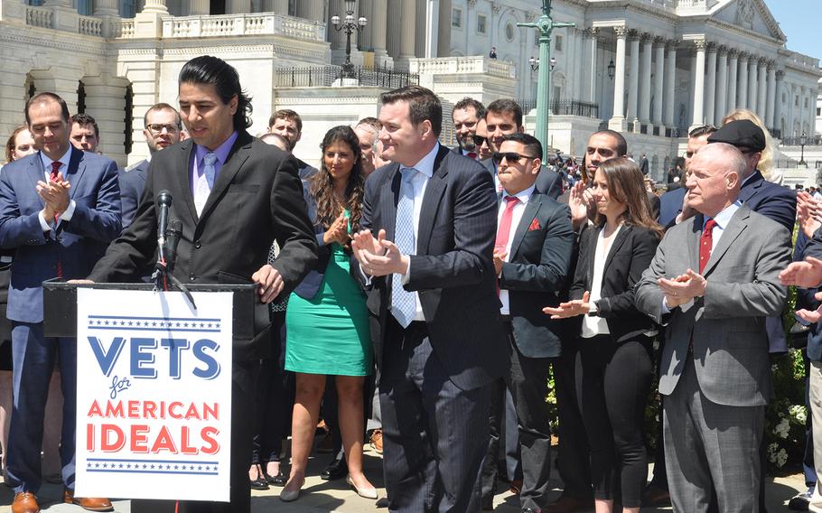 Janis Shinwari, left, a former Afghan interpreter who received a special immigrant visa to come to the U.S., speaks on Capitol Hill Thursday April 26, where he called for continuation of the visa program for other Afghans and Iraqis now facing threats for their work with U.S. forces. Beside him on the right is Matt Zeller, co-founder and CEO of the nonprofit No one Left Behind, who was saved by Shinwari in battle. 
