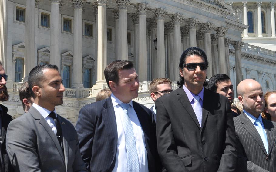 Former Iraqi interpreter Maytham Alshadood, left, No One Left Behind CEO Matt Zeller, center, and former Afghan interpreter Janis Shinwari stand outside the U.S. Capitol on Thursday, April 26, 2018, where they joined with dozens of veterans calling on Congress to keep the special immigrant visa program going. 