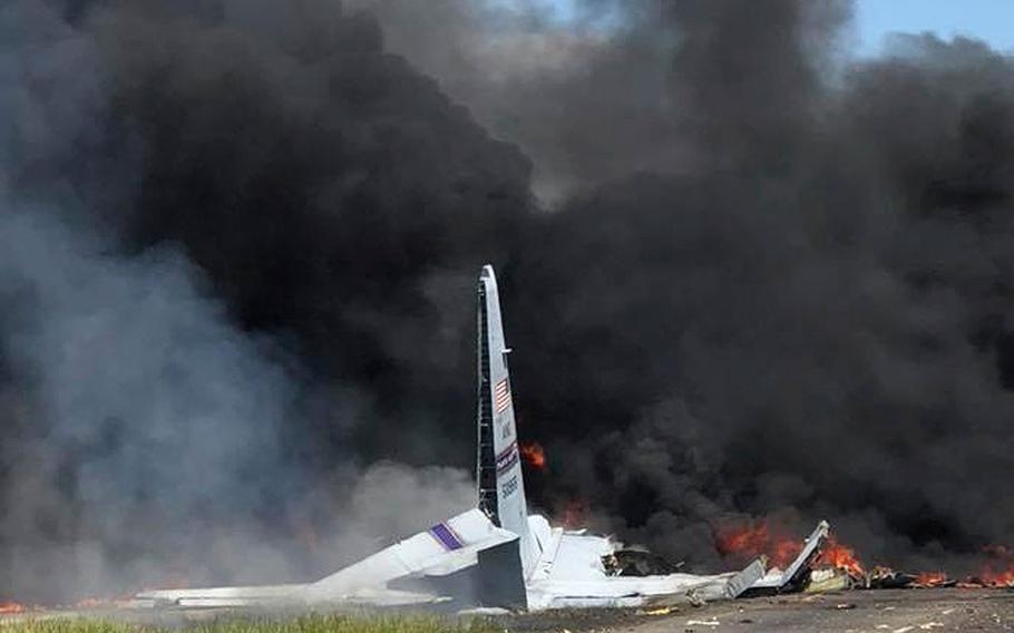 Flames and smoke rise from an Air National Guard C-130 cargo plane after it crashed near Savannah, Ga., Wednesday, May 2, 2018. 