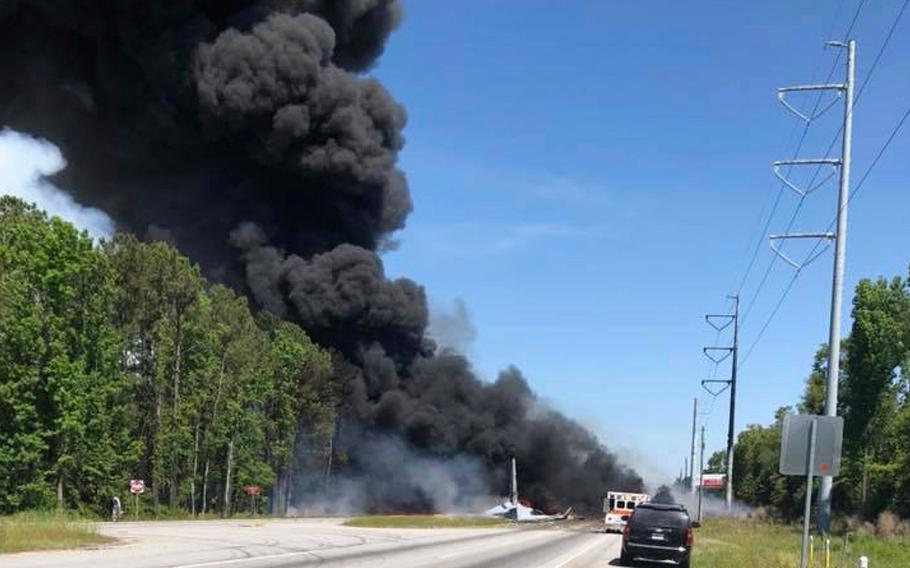 Flames and smoke rise from an Air National Guard cargo plane after it crashed near Savannah, Ga., Wednesday, May 2, 2018. 