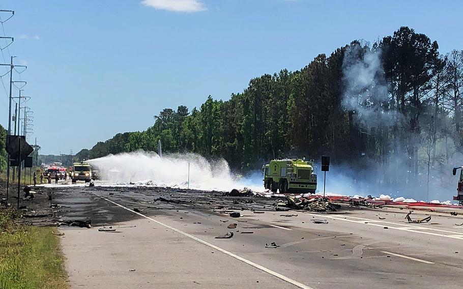 Emergency personnel work at the scene of an Air National Guard cargo plane that crashed near Savannah, Ga., Wednesday, May 2, 2018. 