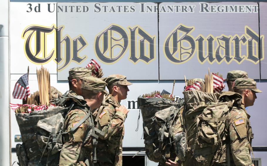 The U.S. Army's 3rd Infantry Regiment, better known as The Old Guard, pass through the gates to Arlington National Cemetery for Flags In on May 24, 2018.