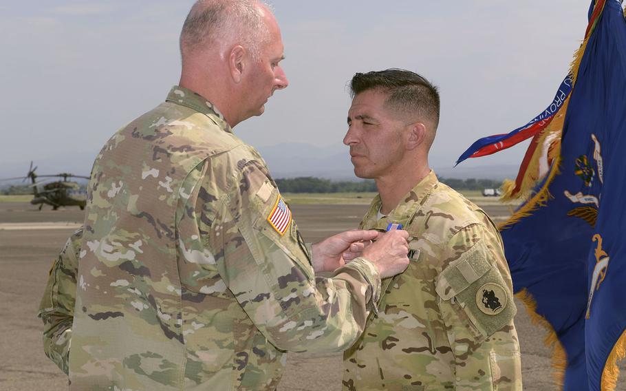 Col. Keith McKinley presents Sgt. 1st Class Levon Fernandez with the Soldier's Medal on May 7, 2018, at Soto Cano Air Base in Honduras.