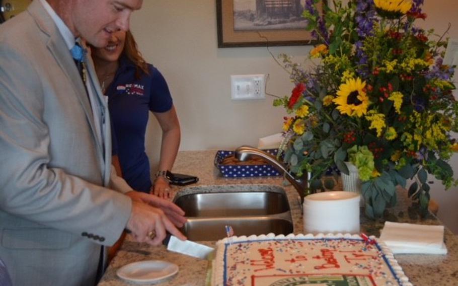 Ty Carter cuts a cake during a home unveiling celebration in his honor on June 14, 2018. The Texas Sentinels Foundation donated the home in Bastrop, Texas, to Carter debt-free. Photo by Rose L. Thayer.