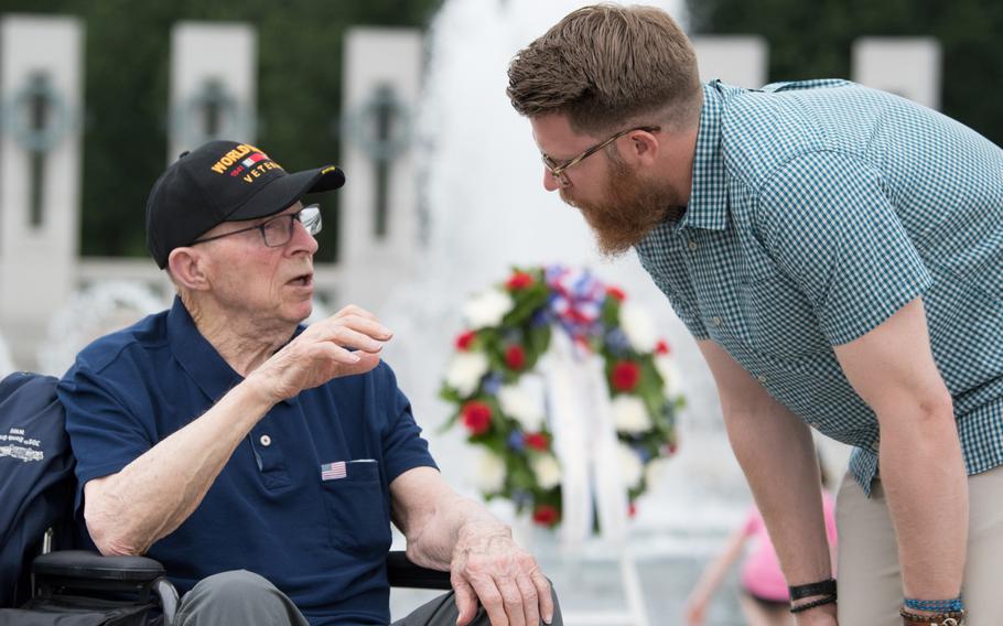 Washington Nationals pitcher Sean Doolittle speaks with Air Force veteran Charles Drew at a ceremony honoring the 75th anniversary of the Battle for the Skies, the air war during WWII. Doolittle is a distant cousin of Air Force General James Doolittle. Drew retired as a Master Sergeant after a career as a radio operator and combat photographer on B-17 planes.
