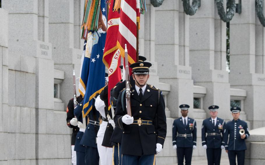 Members of the Armed Forces present the colors during the 75th anniversary of the Battle for the Skies ceremony at the National World War II Memorial on June 20. 