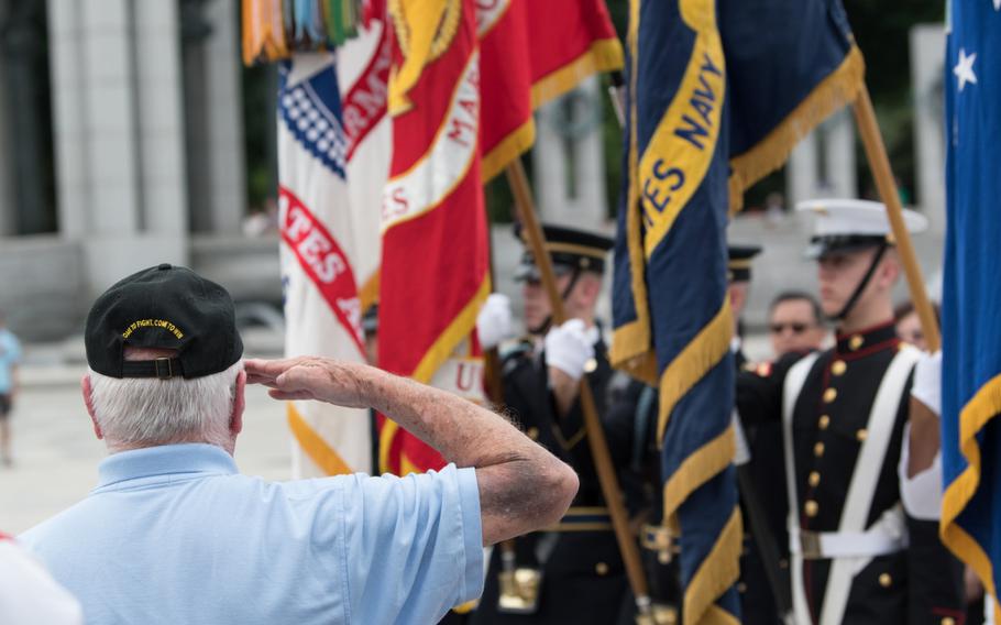 An attendee salutes the colors during the 75th anniversary of the Battle for the Skies ceremony at the National World War II Memorial on June 20. 