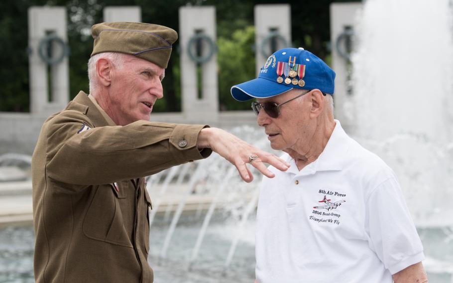Dr. Jack Goldstein, a veteran of the Eighth Air Force, speaks with a volunteer from the National World War II Memorial after a ceremony to honor the Air Force on June 20. 