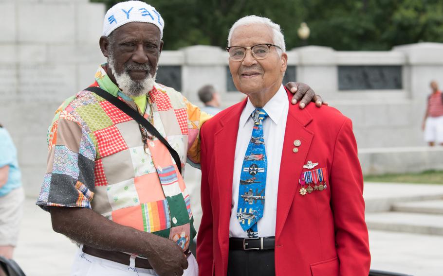 Michael Boykin, of Miami, Florida, shakes hands with Charles McGee, a veteran of the Tuskegee Airmen. Boykin was on vacation and visiting the National World War II Memorial when he met McGee after the ceremony on June 20. "I've always wanted to meet one of the Tuskegee Airmen," said Boykin. 