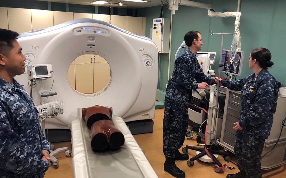 Sailors demonstrate the CT scanner aboard the USNS Mercy on the hospital ship during a port visit to Yokosuka, Japan, on June 15, 2018. 