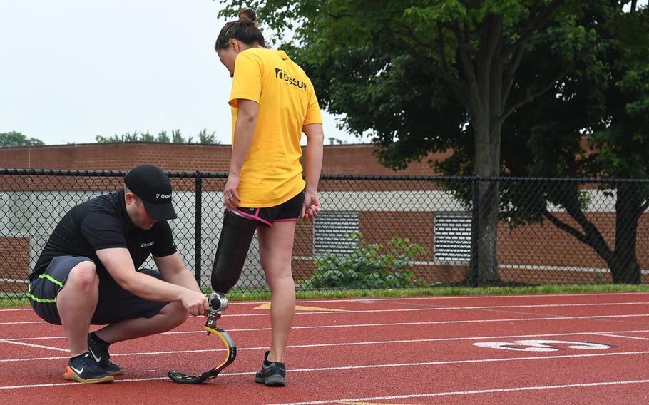 A participant in the Challenged Athletes Foundation clinic has her prosthetic adjusted on-site by a professional from Ossur, the partnering orthopedics company, on June 23, 2018.