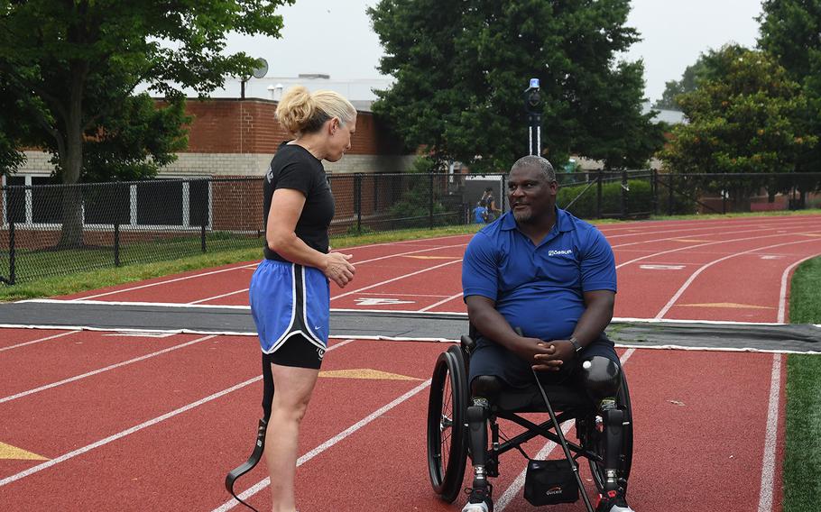 Retired Army Colonels Gregory Gadson and Patty Collins talk before the Challenged Athletes Foundation clinic on June 23, 2018 at Catholic University. Gadson and Collins came to the event to support and inspire the amputees participating and learning new walking and running techniques. 