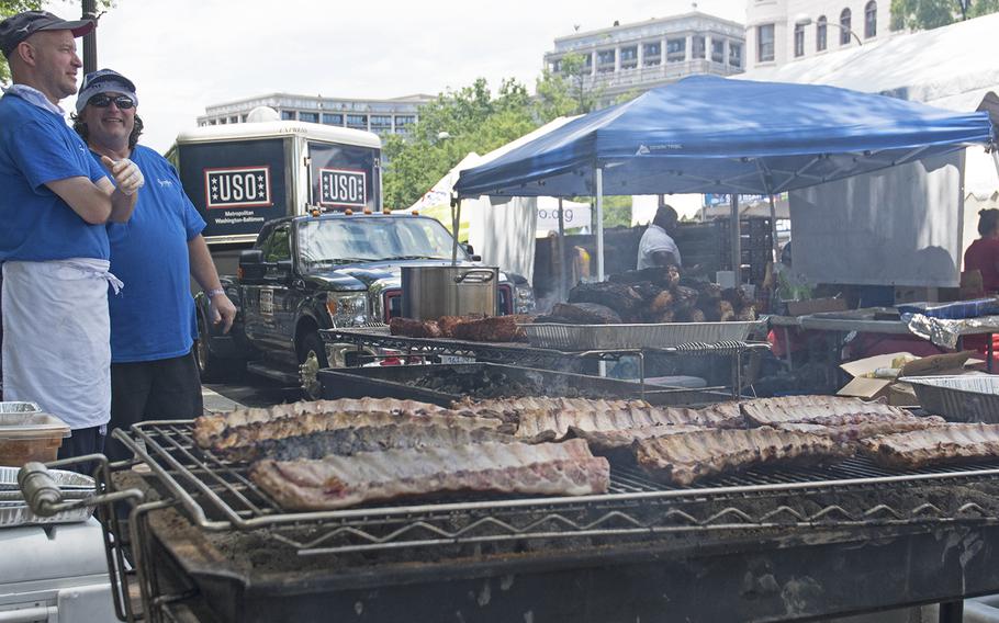 John Oravec, right, a culinary instructor at Stratford University, chats at the Military Cook-Off at the 2018 Giant National Capital Barbecue Battle, Sunday, June 24, 2018.