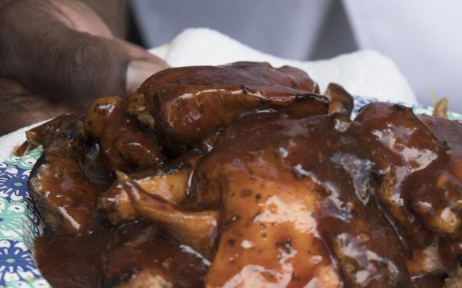 Ret. Army Master Sgt. Andre Rush shows off his pork tenderloins at the Military Cook-Off at the 2018 Giant National Capital Barbecue Battle, Sunday, June 24, 2018.