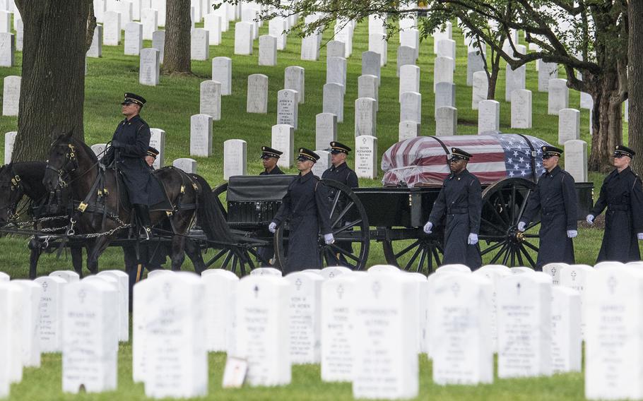 A flag-draped coffin carries the commingled remains of five World War II airmen who died during a mission in Germany in 1944. They were buried together at Arlington National Cemetery on June 27, 2018.