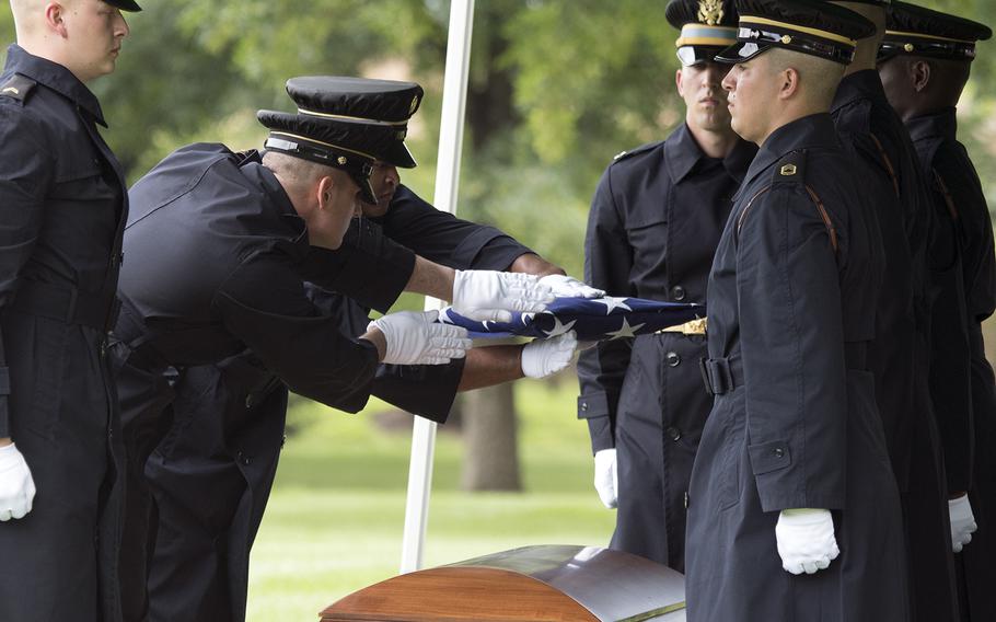 The Old Guard fold a flag over the coffin of Staff Sgt. Robert Shoemaker during a funeral at Arlington National Cemetery for five airmen killed during World War II on June 27, 2018.