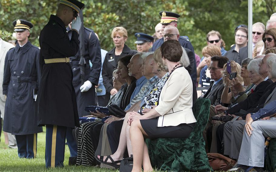 A family member is saluted during a funeral at Arlington National Cemetery on June 27, 2018, of five airmen killed during WWII.