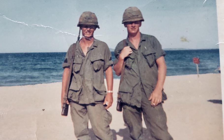 Soldiers Bob Hart, left, and Ron Ridgen, right, stand for a photo at the South China Sea. Hart, drafted at age 19, was a radio operator in 1966 and 1967 during the Vietnam War, where he was exposed to the chemical herbicide Agent Orange.