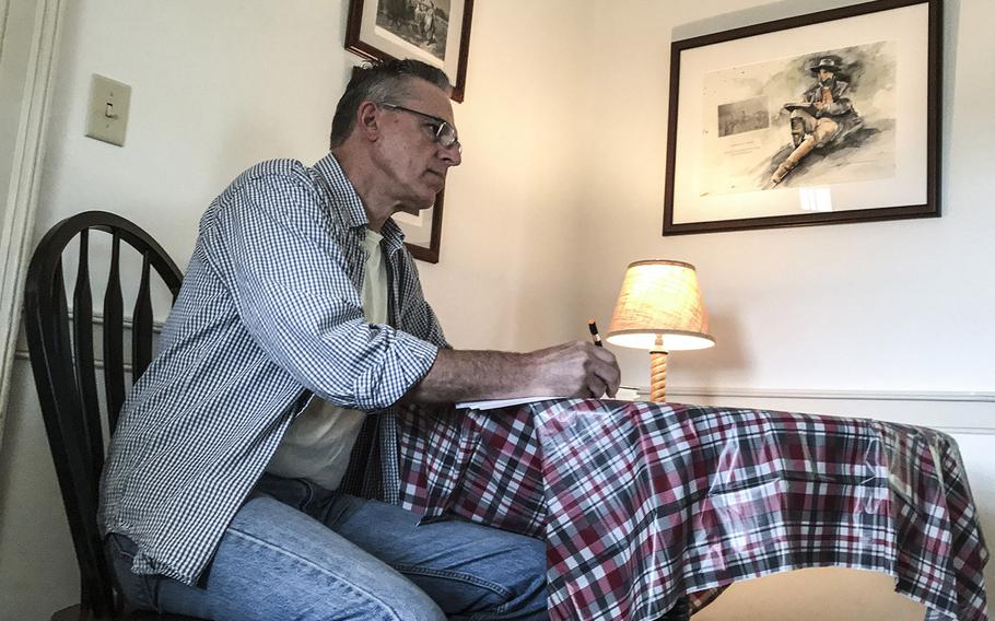 Gettysburg Artist-in-Residence Rick Stark Jr. goes over his notes for a recently-written poem.