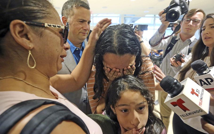 Alejandra Juarez, 38, left, says goodbye to her children, Pamela and Estela at the Orlando International Airport on Friday, Aug. 3, 2018 in Orlando, Fla.