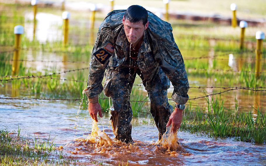 Master Sgt. Christopher Nelms, U.S. Special Operations Command, finishes a low craw under the “worm pit” at the Malvesti Obstacle Course in the Best Ranger Competition on April 13, 2013 at Fort Benning.
