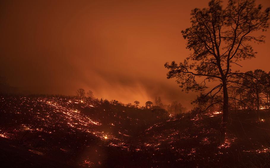 A hillside smolders after flames passed through during the Ranch Fire in Clearlake Oaks, Calif., on Sunday, Aug. 5, 2018.