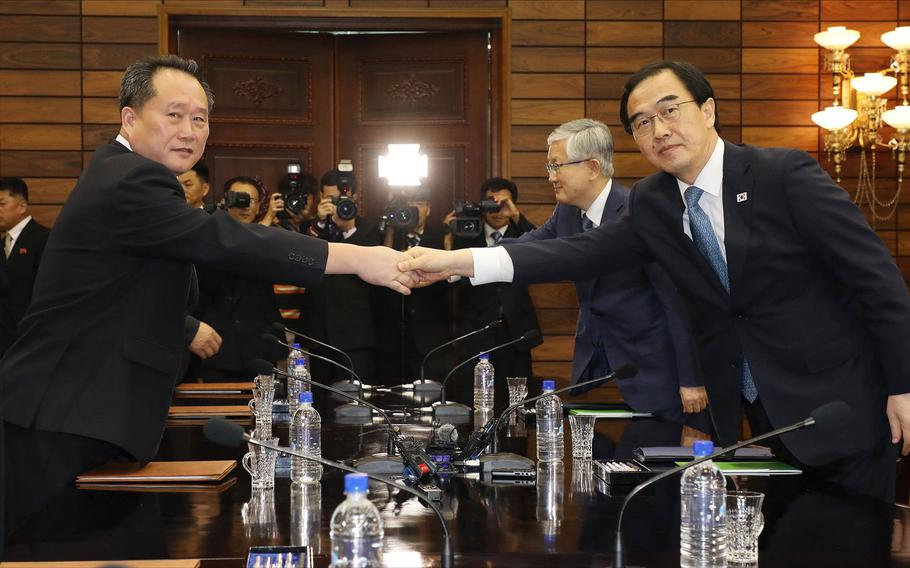 South Korean Unification Minister Cho Myoung-gyon, right, shakes hands with his North Korean counterpart Ri Son Gwon during their meeting at the northern side of Panmunjom in the Demilitarized Zone, North Korea, Monday, Aug. 13, 2018. Senior officials from the rival Koreas met Monday to set a date and venue for a third summit between South Korean President Moon Jae-in and North Korean leader Kim Jong Un, part of an effort to breathe new life into resolving the nuclear standoff between Washington and Pyongyang.