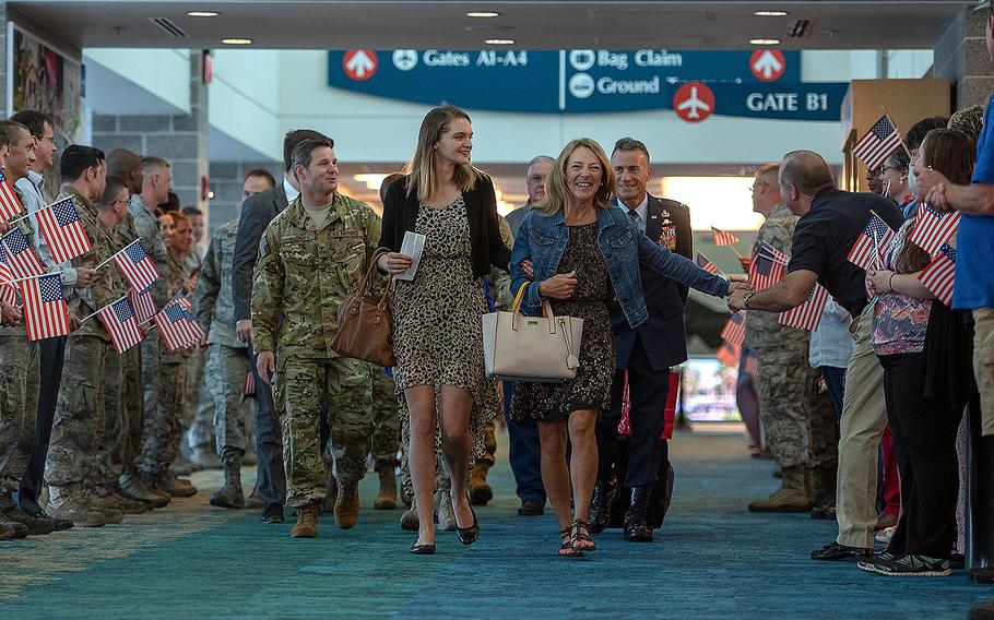 Valerie Nessel, right, the widow of U.S. Air Force Tech. Sgt. John Chapman, walks alongside her daughter Brianna, center, at Destin-Fort Walton Beach Airport, Florida on Aug. 20, 2018. 