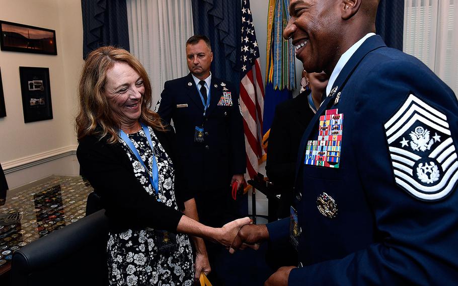 Chief Master Sgt. of the Air Force Kaleth O. Wright greets Valerie Nessel, the spouse of U.S. Air Force Tech. Sgt. John Chapman, at the Pentagon in Arlington, Virginia on Aug. 21, 2018. 
